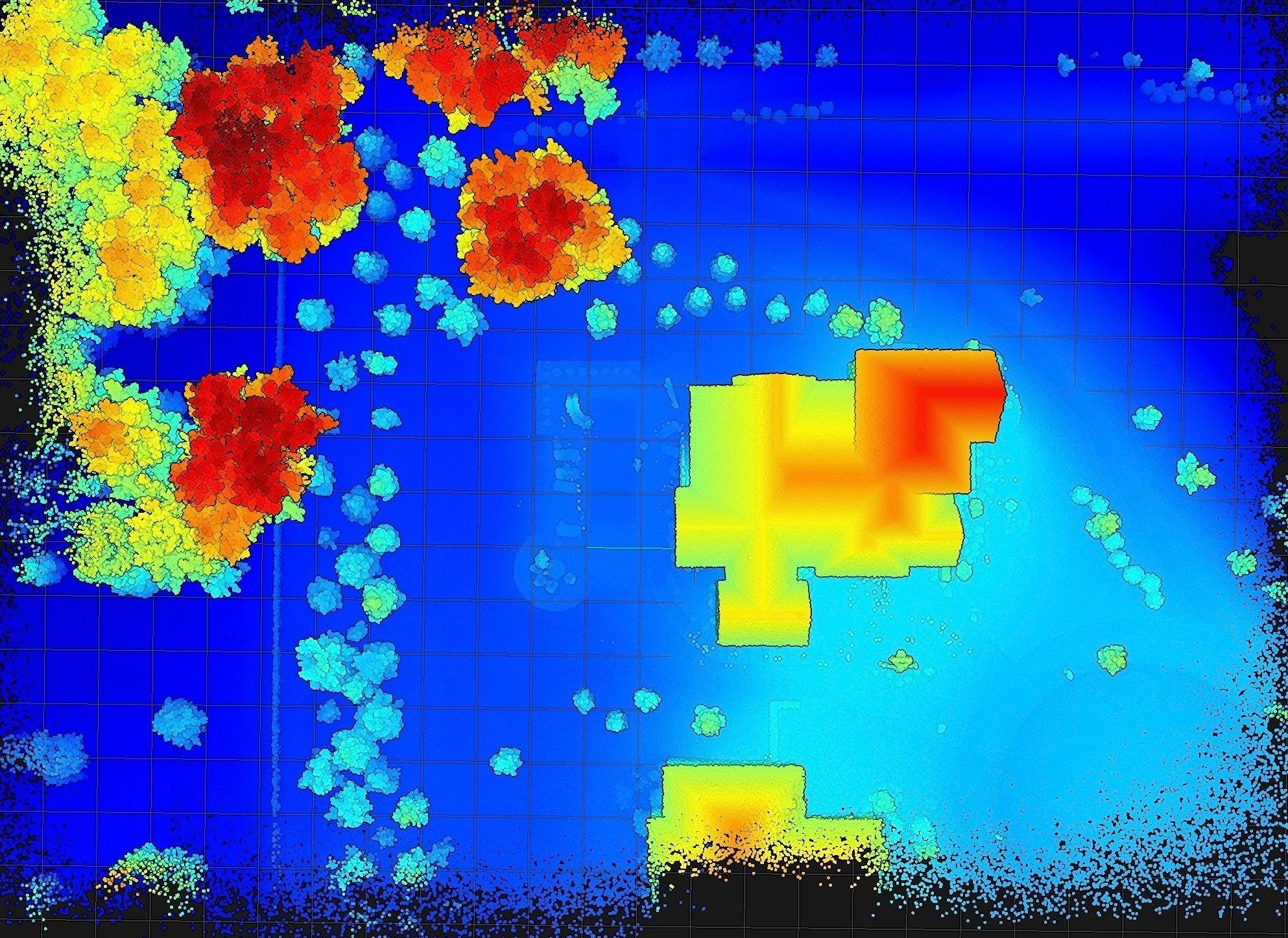 Dense true-LiDAR point cloud of the wooded residential estate colorized by elevation — deep-blue ground rising through cyan and green to yellow and red tree canopy, with the building footprints resolved on a measurement grid