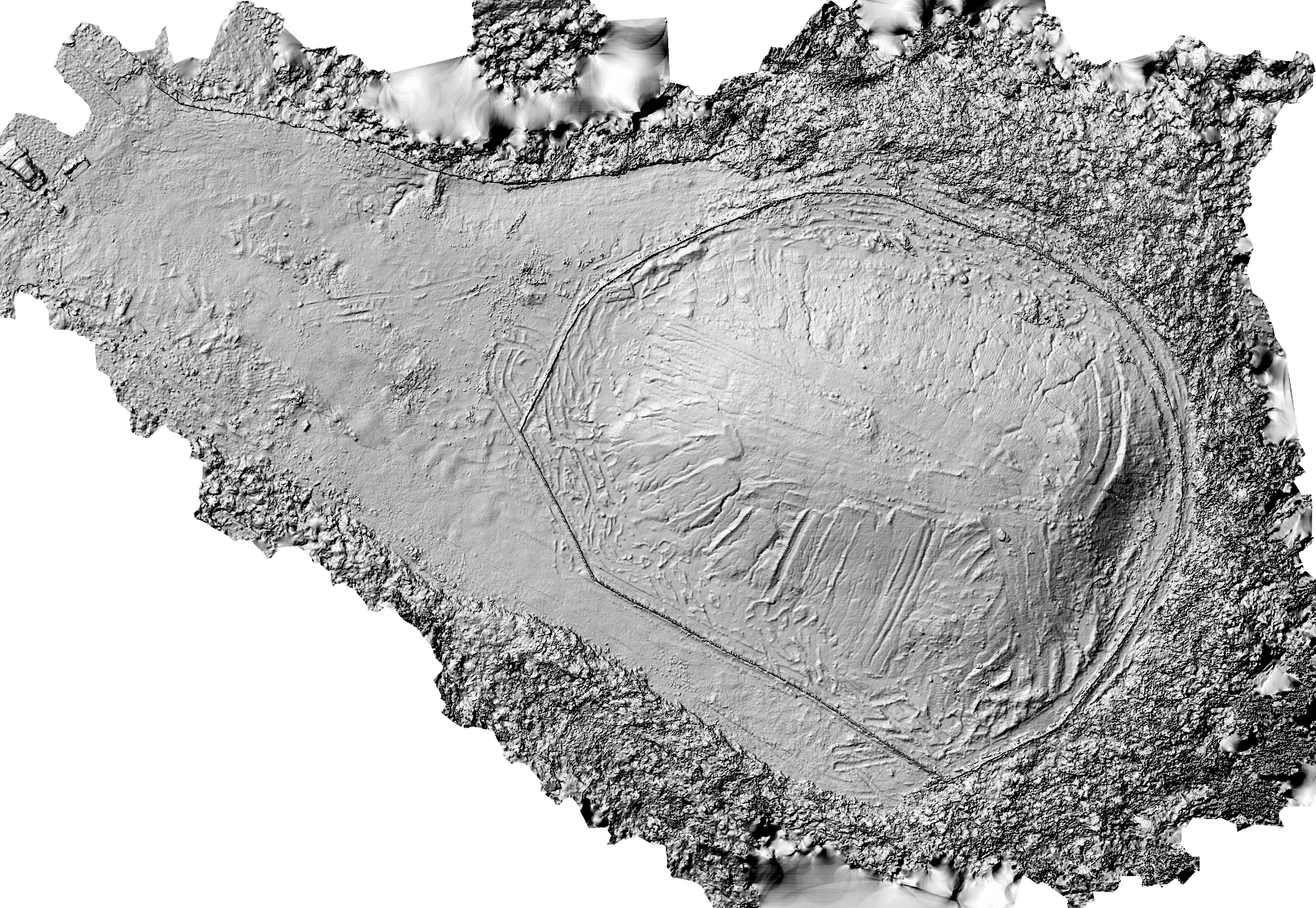 Grayscale hillshade relief exposing a large graded oval stockpile, tire paths, drainage patterns, and disturbed soil across the site