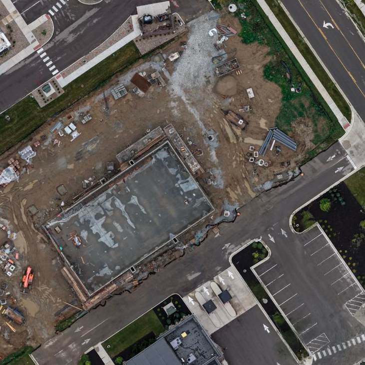 High-resolution top-down orthomosaic of the Westfield construction site — foundation pad, parking, roadways, and graded earthwork rendered as a measurable full-color map