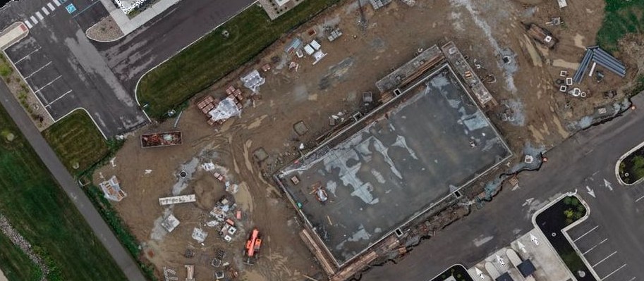 True-color orthomosaic of the construction site — foundation pad, parking, roadways, and graded earthwork