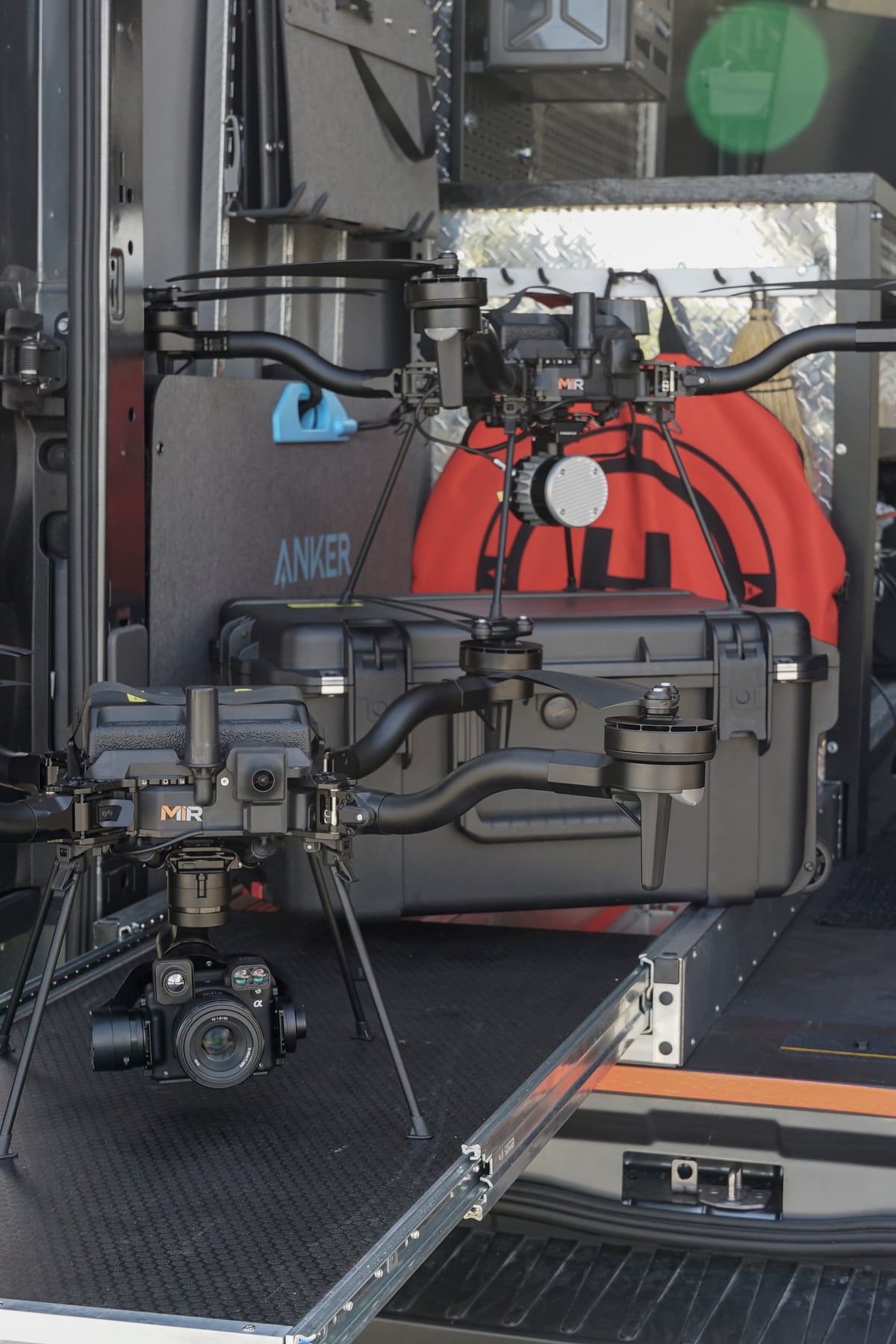 MIR-branded American-made Freefly Astro aircraft with Sony camera and LiDAR gimbal payloads staged with Pelican cases on a mobile command truck, ready to deploy
