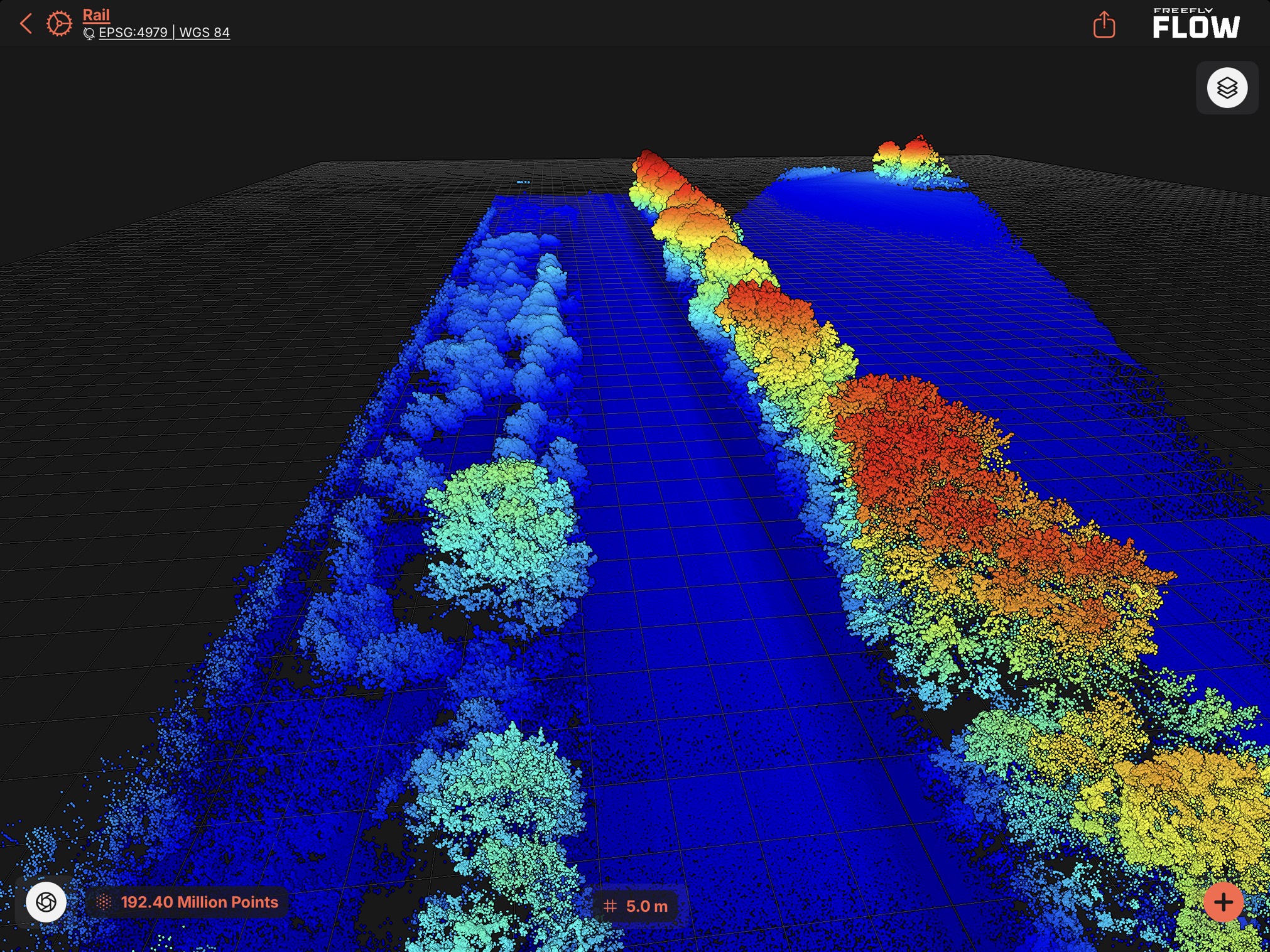 Rail-corridor LiDAR point cloud of 192.4 million points in Freefly Flow, colored by elevation to show track, ballast, terrain, and adjacent vegetation for clearance-envelope analysis