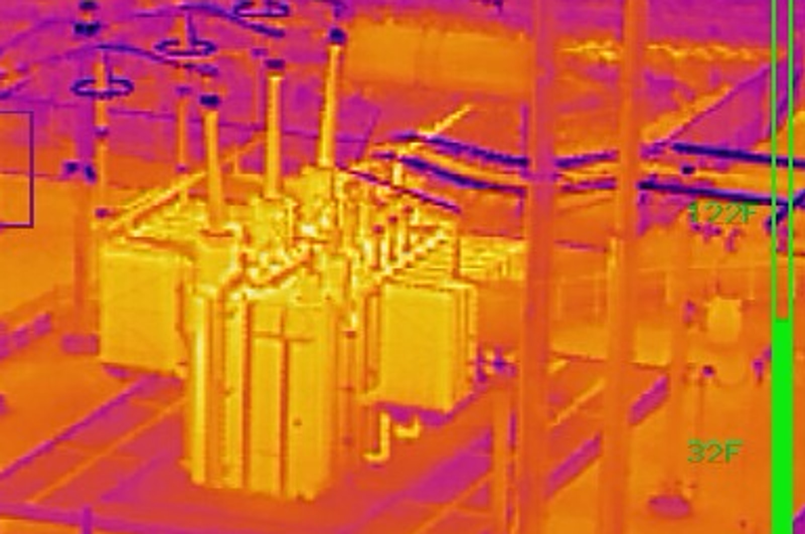 Radiometric thermal aerial of the same substation in ironbow palette, revealing heat signatures across the transformer, connections, and hardware
