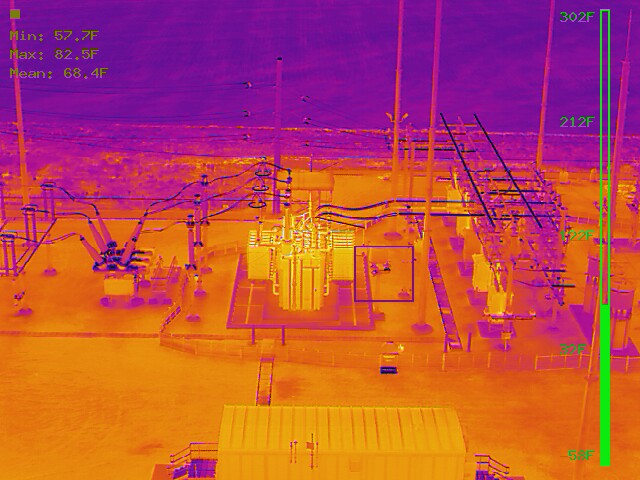Radiometric thermal aerial of the wind farm collector substation showing transformers, buswork, and insulators, with min 57.7°F, max 82.5°F, and mean 68.4°F readouts and a temperature scale