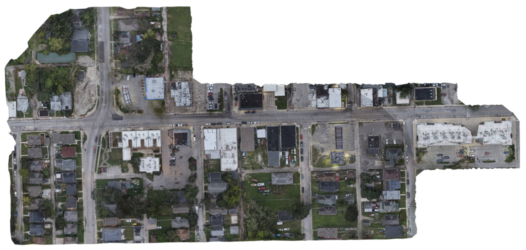 True-color RGB orthomosaic of the surveyed city blocks, showing streets, rooftops, parking lots, vegetation, and vehicles from directly overhead